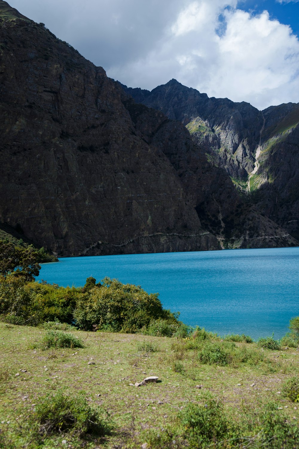 a body of water with mountains in the back