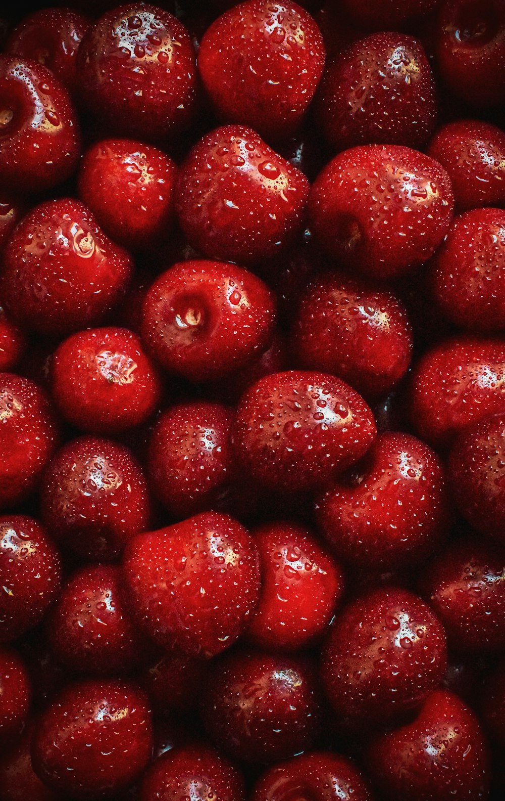 a pile of red cherries