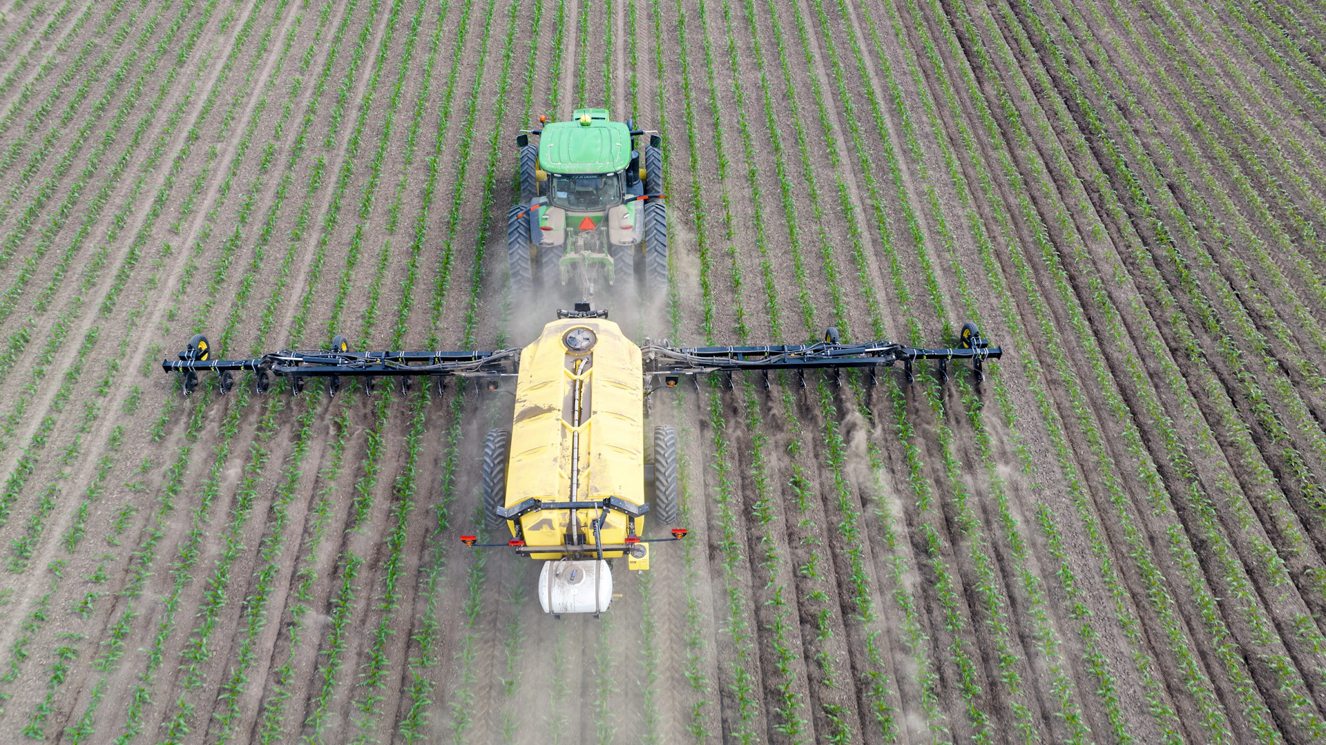 Agricultural machinery working a crop field