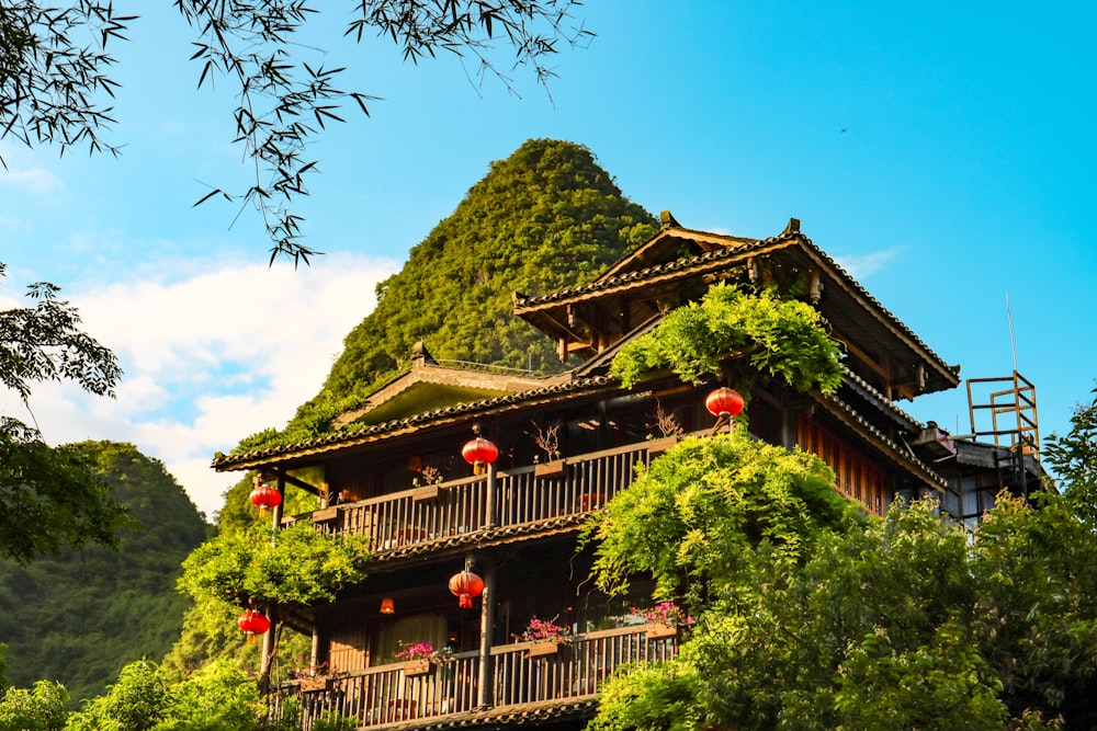 a wooden building with a deck and trees around it