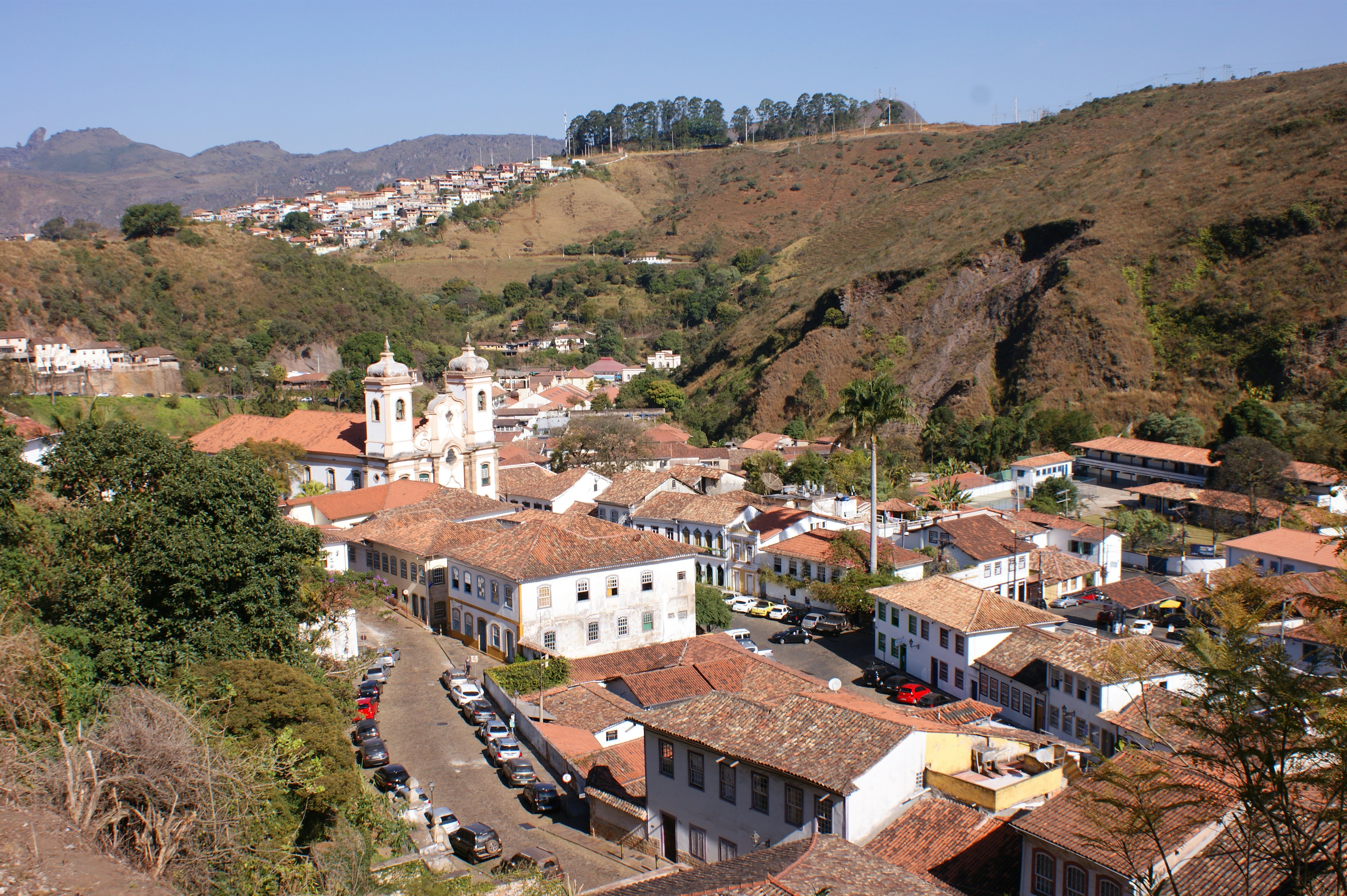 White colonial church with ceramic tile decorations on facade, bright midday sun, clear sky