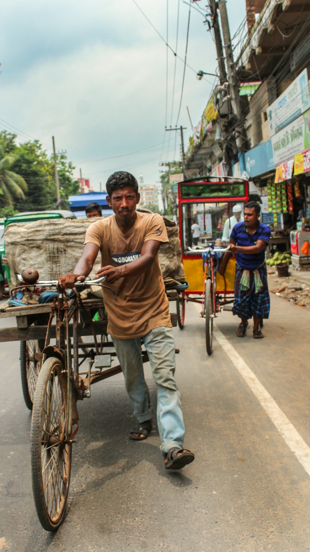 a man pushing a cart with a person on it