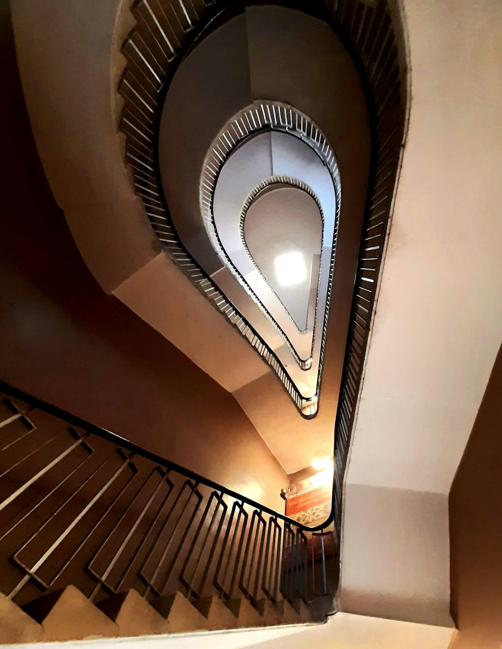 a spiral staircase with a light at the top