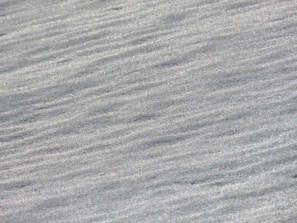 Brushed stainless steel sheet with a subtle, sophisticated finish.