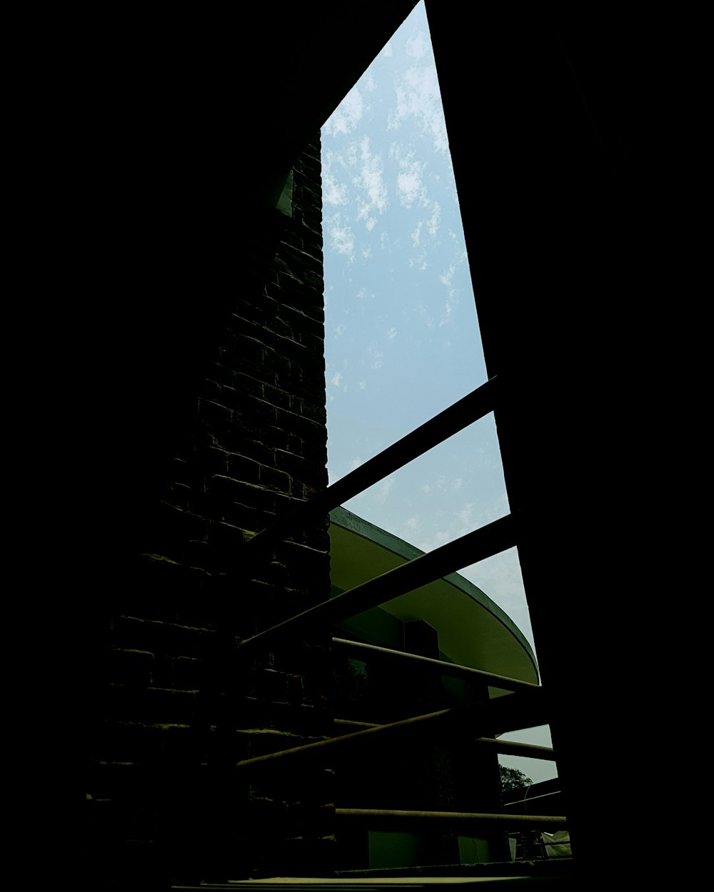 a view of the sky through a window of a tall building