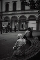 A cinematic image of an elderly person sitting on a bench, lost in thought with soft natural light.