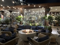 Outdoor patio area with comfortable seating and a sleek fire pit, perfect for evening gatherings.