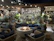 Elegant fire feature surrounded by built-in seating, framed by lush planting under subtle lighting.