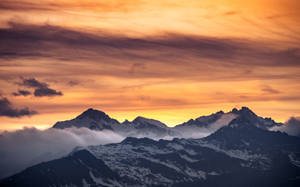 a mountain range with clouds