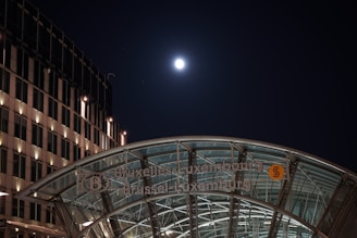 Cinematic shot of sleek glass buildings in Brussels' European quarter under a soft morning light.