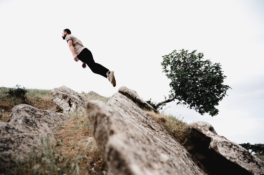 a man jumping off a cliff
