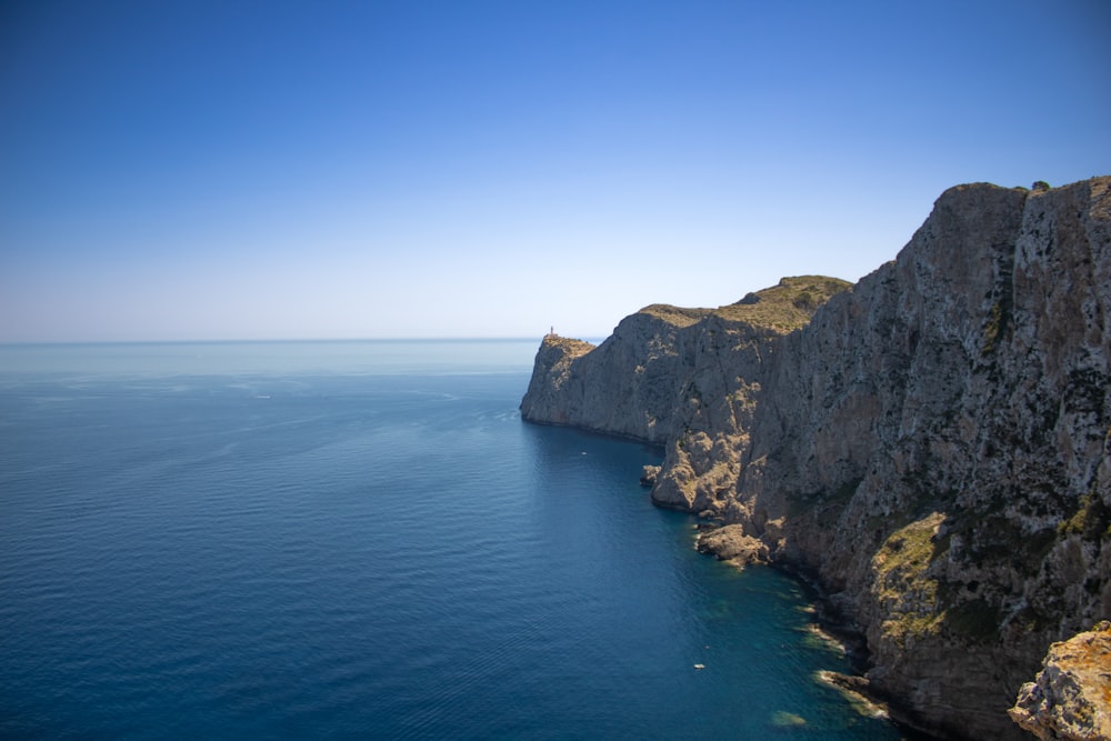 a cliff next to the ocean