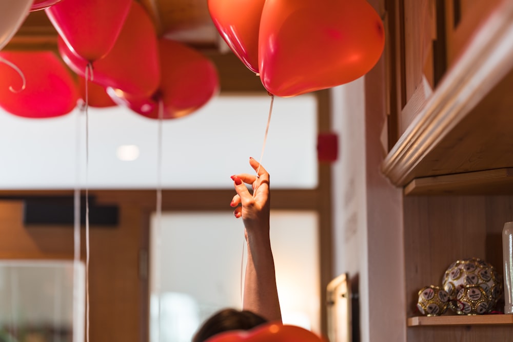 a person holding a bunch of balloons