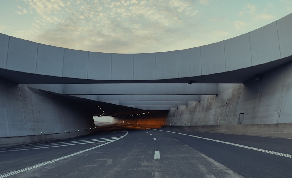 a large grey building with a road