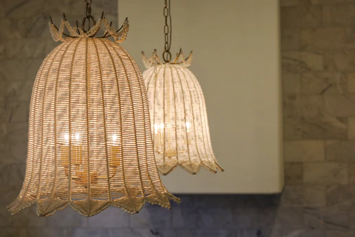 An elegant custom home interior showcasing textured stone walls and a black geometric pendant light sculpture