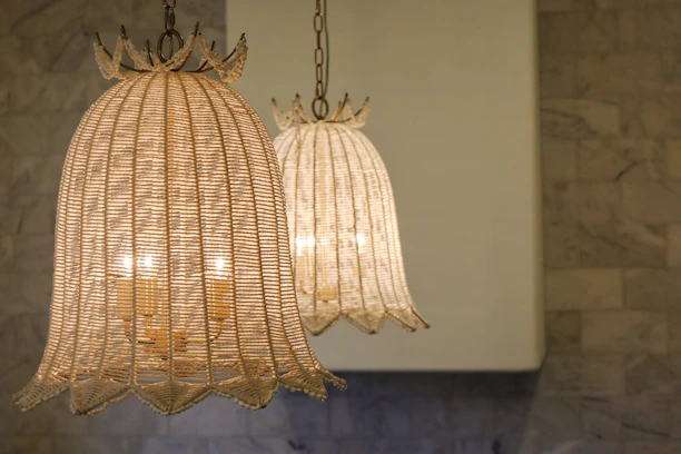 A warm, inviting living room with handcrafted textiles and soft glowing pendant lights.