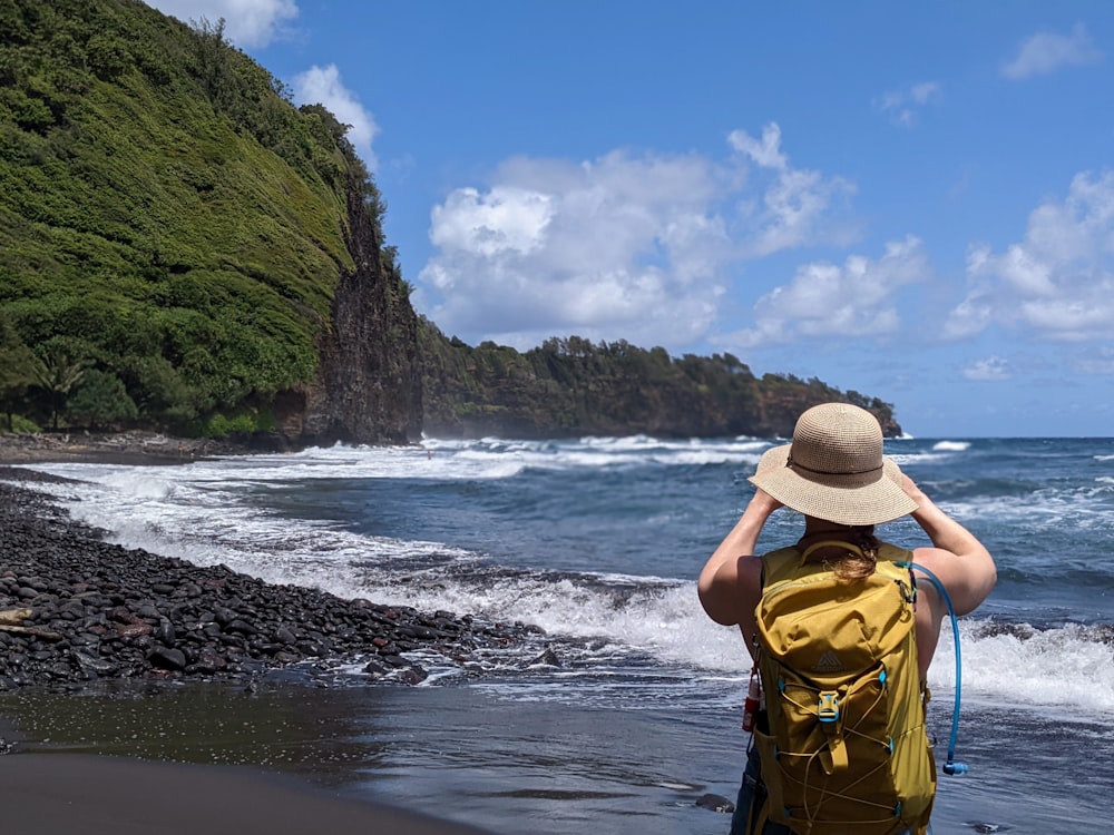 a person in a hat on a beach