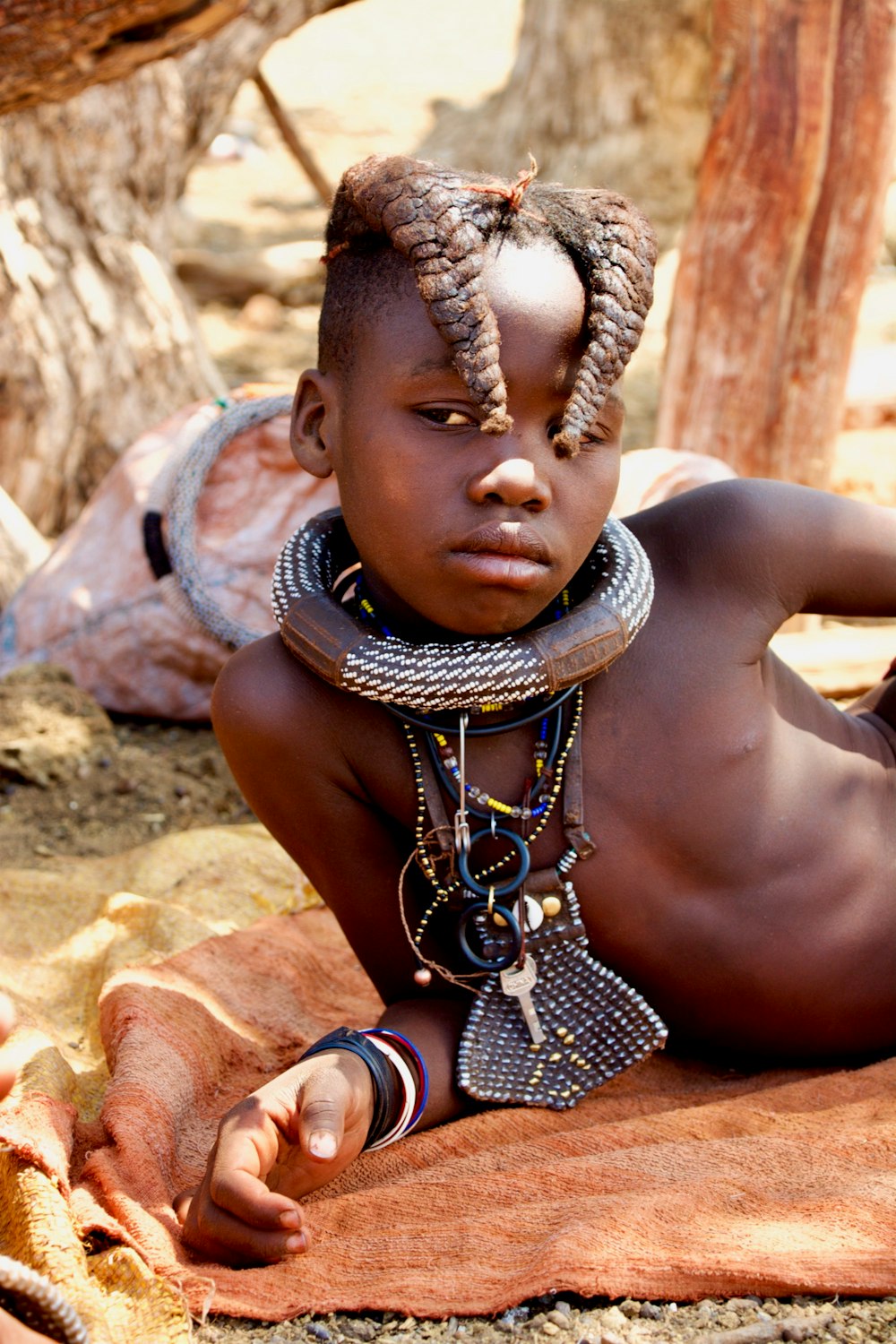 a young boy with a necklace