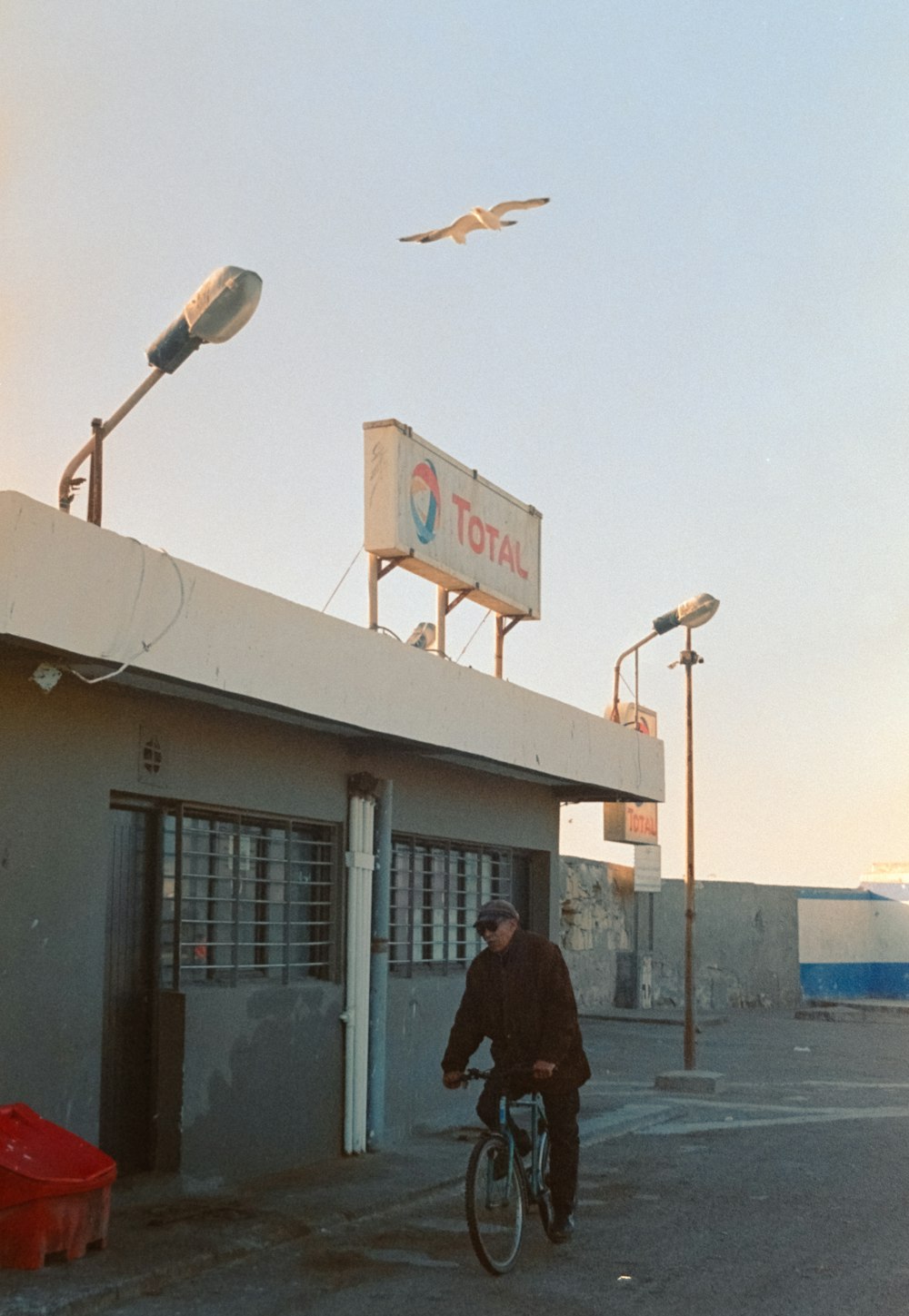 a man riding a bicycle in front of a store