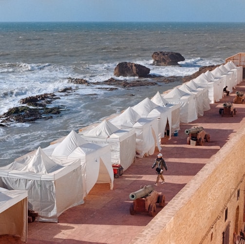 a group of tents next to a beach