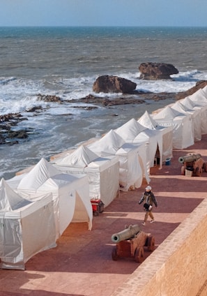 a group of tents next to a beach