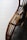 Curved wooden rods with a smooth finish are intricately woven and joined, possibly forming a part of furniture. A plush, grey furry blanket or cushion is visible, adding texture and warmth to the scene.