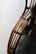 Curved wooden rods with a smooth finish are intricately woven and joined, possibly forming a part of furniture. A plush, grey furry blanket or cushion is visible, adding texture and warmth to the scene.