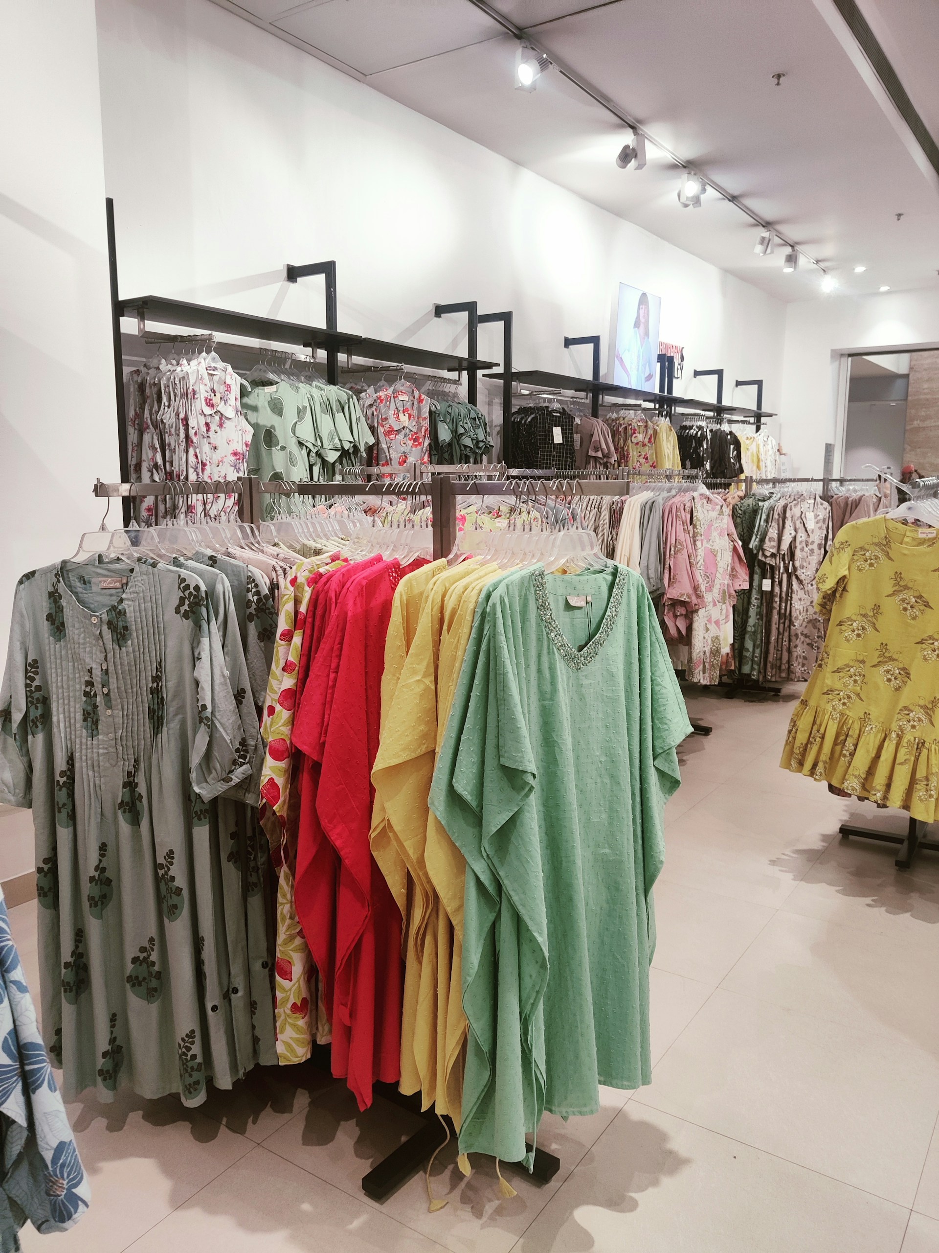 a store with a variety of clothes on the racks