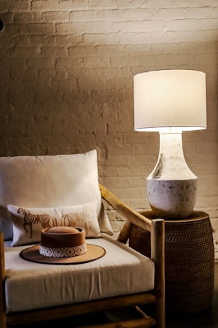 A cozy corner setup featuring luxury cushions and a stylish lamp.