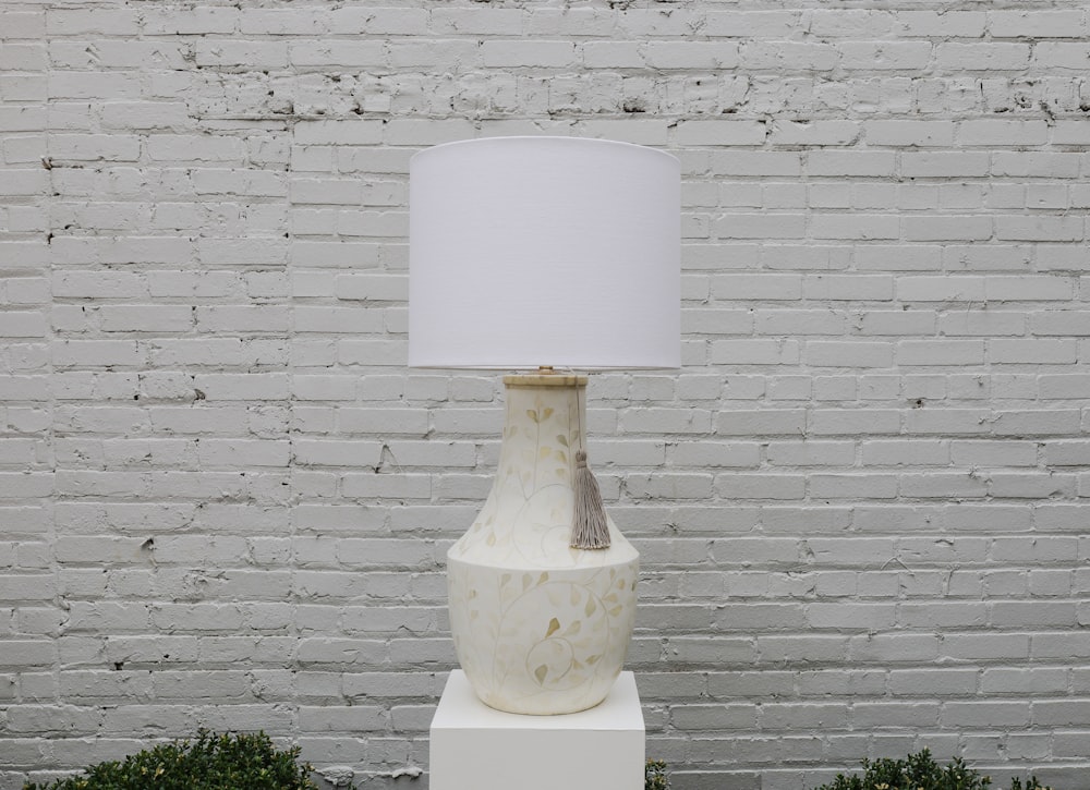 a white vase with a white top