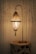 An artistic driftwood lamp placed elegantly on a rustic wooden table.