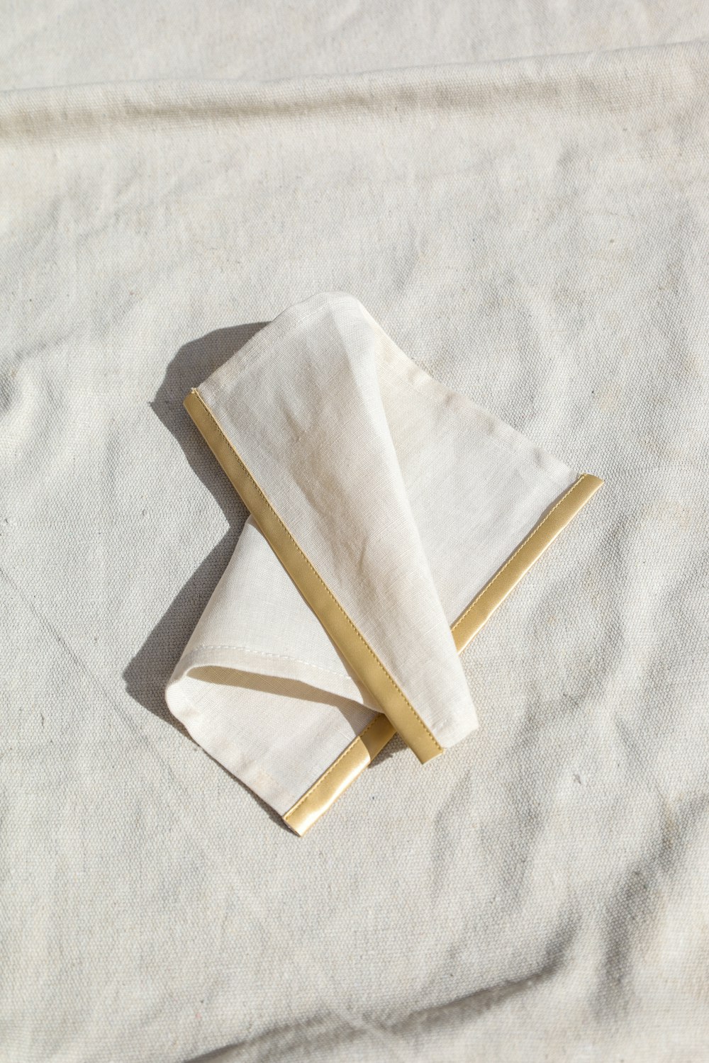 a paper airplane on a white surface