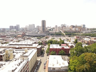 Aerial view of a cityscape with diverse residential and commercial buildings.