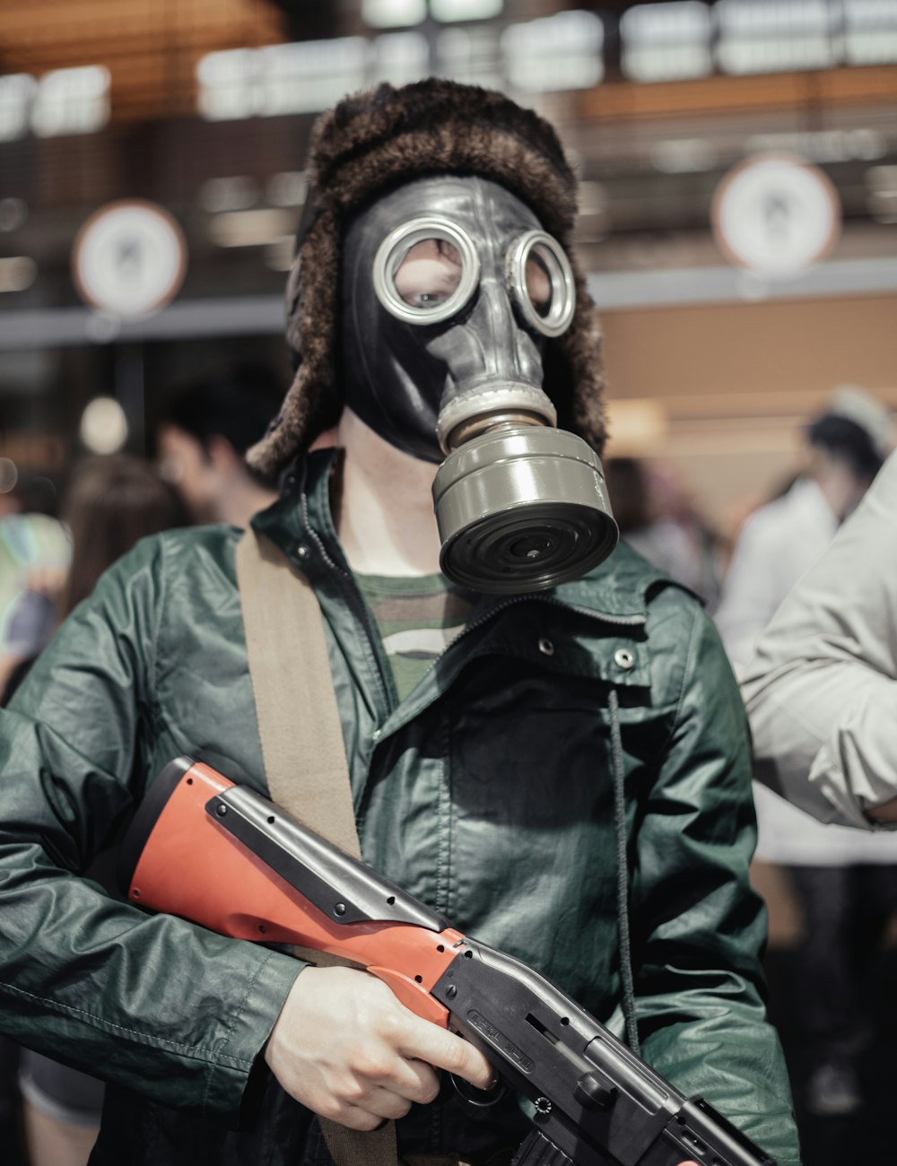 a man wearing a gas mask and holding a gun