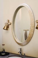 Elegant bathroom featuring a clean design and a large mirror.