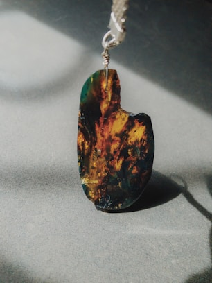 Close-up of a smooth, polished jade pendant glowing softly in natural light