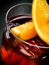 a glass of liquid with lemons