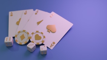 A set of playing cards displaying four aces is laid out on a surface. Alongside them, there are two poker chips with heart and diamond symbols, and three six-sided dice showing different numbers. The background is a smooth gradient of purple, creating a thematic gaming or casino atmosphere.