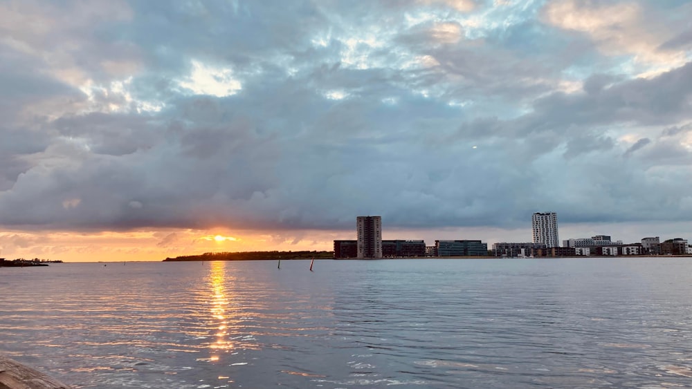 a body of water with buildings in the background