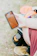 A happy man holding a smartphone displaying the baseball scoring app during a sunny game.