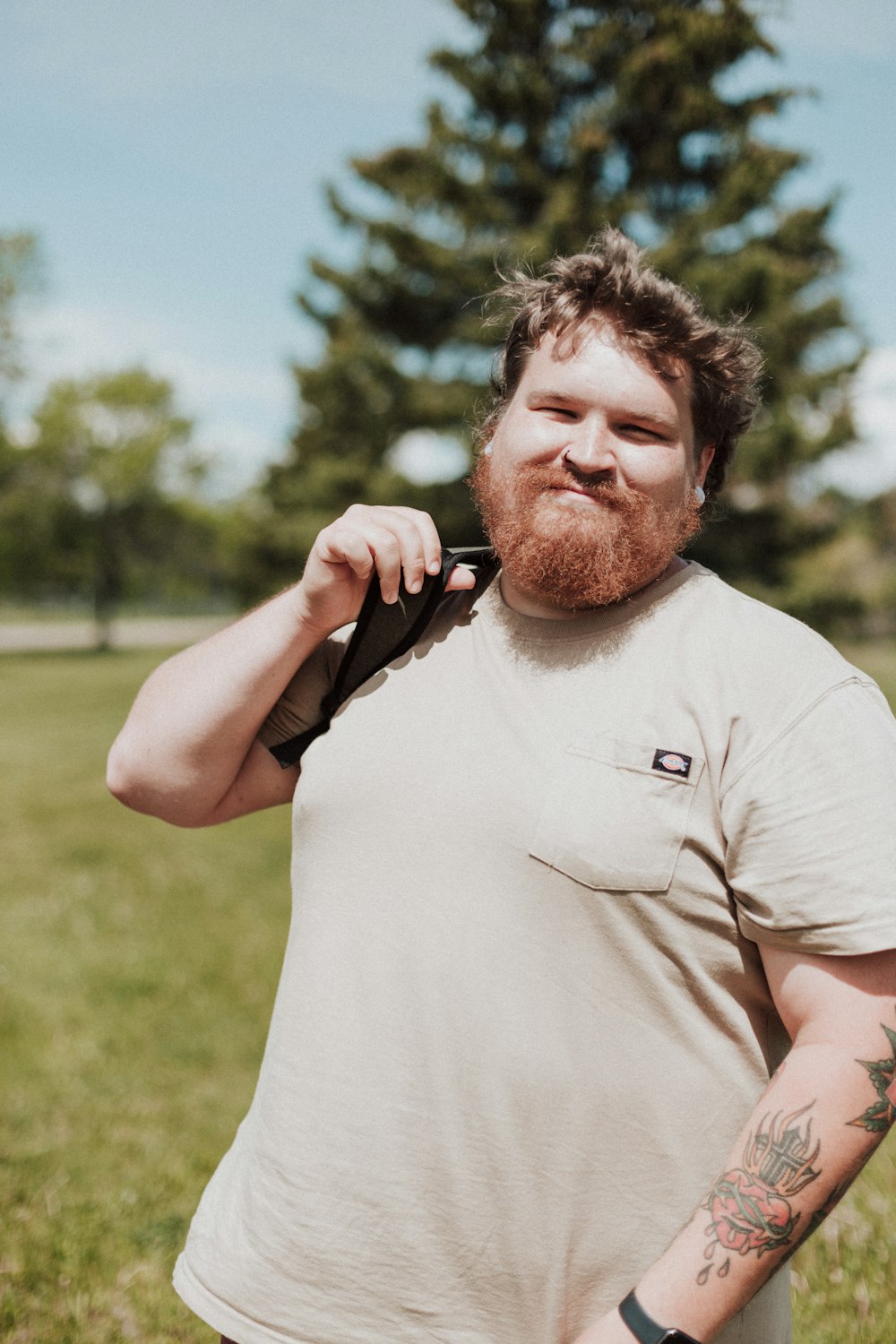 a man with a beard holding a gun