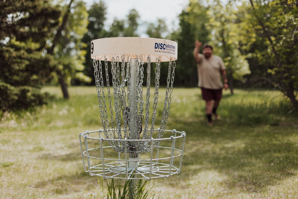 a person throwing a frisbee in a frisbee goal