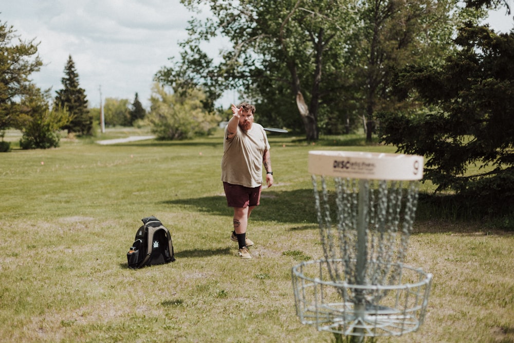 a person stands next to a bird feeder