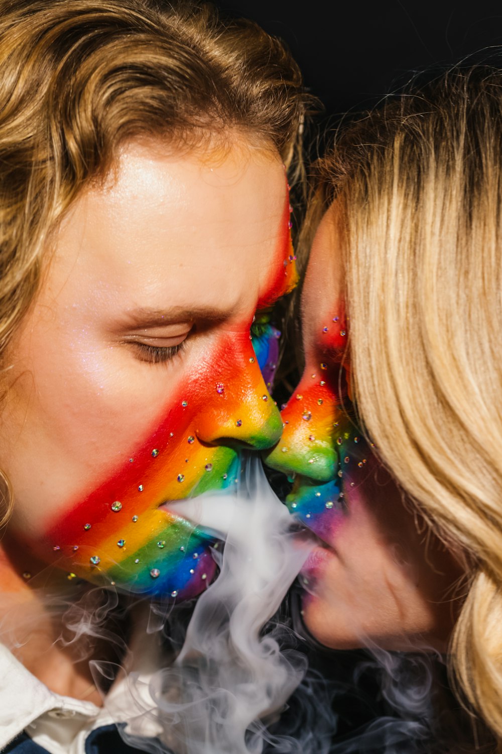 a person kissing another woman