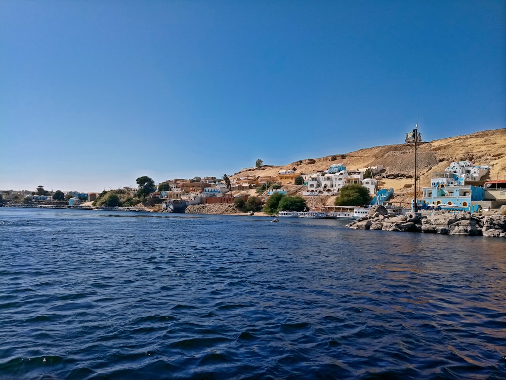 a body of water with a town on the other side of it