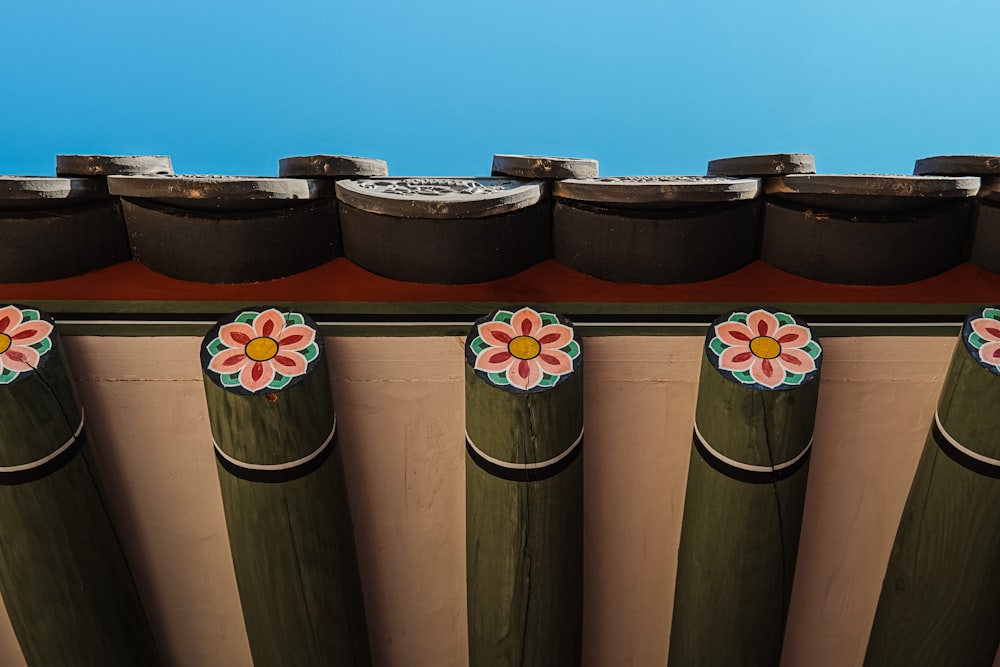 a row of wooden posts with flowers