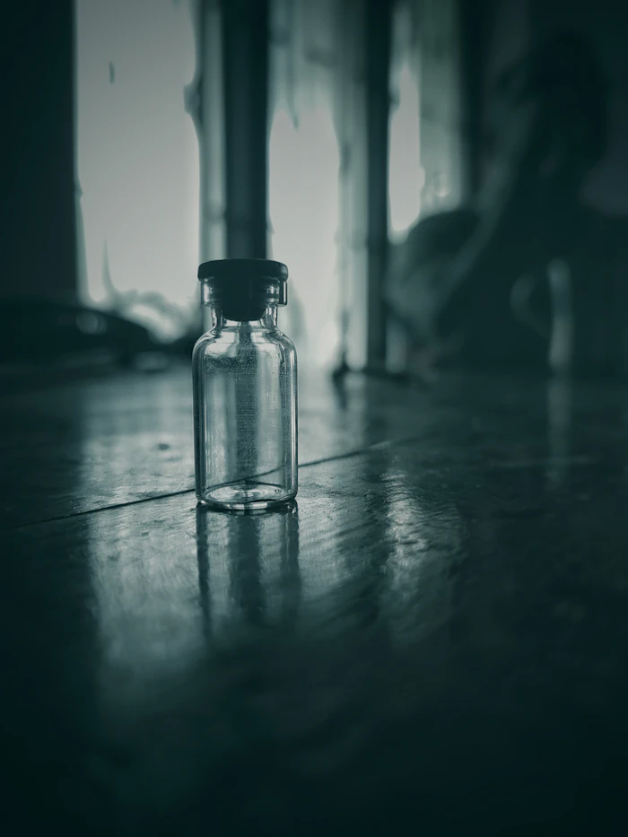 A small glass bottle in low light