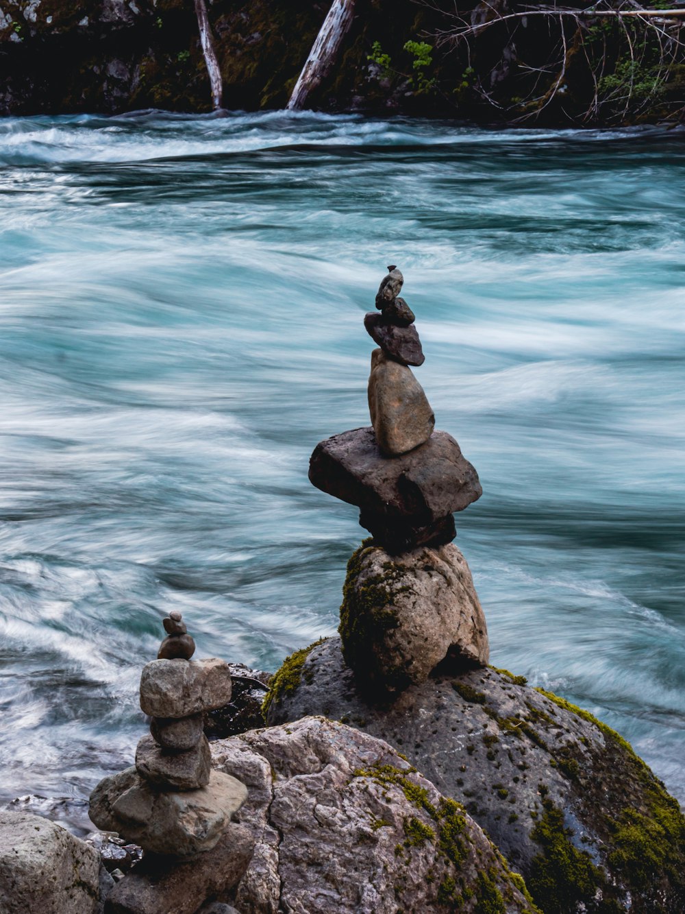 a group of rocks by a body of water