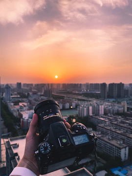 A professional camera capturing a vibrant cityscape at sunset.
