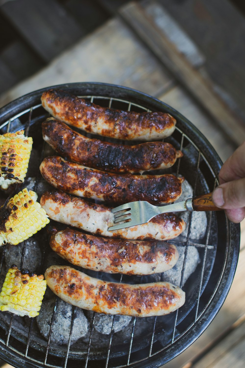 a grill with meat and corn